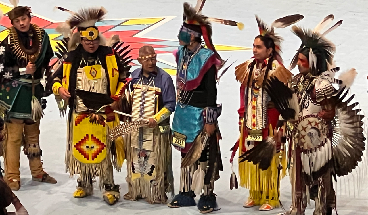 Gathering of Nations Elder Dancer with Young Dancers - A moment in time